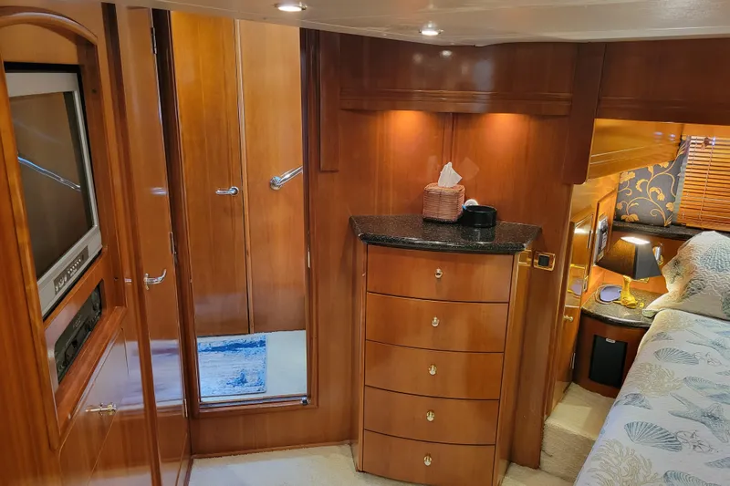  Yacht Photos Pics Luxurious interior of 2001 Carver 570 Voyager Pilothouse with wood cabinetry and cozy bedroom.