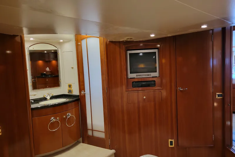  Yacht Photos Pics Luxurious interior of 2001 Carver 570 Voyager Pilothouse with wood paneling and built-in TV.