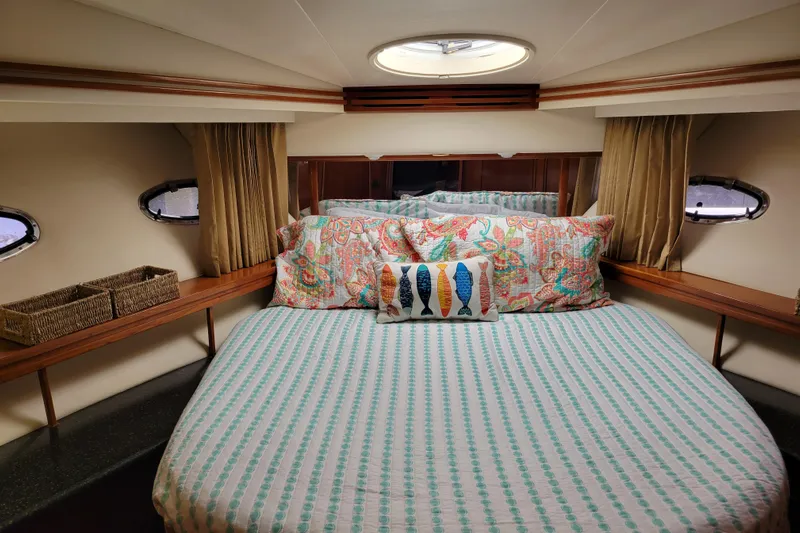  Yacht Photos Pics Luxurious bedroom interior of 2001 Carver 570 Voyager Pilothouse yacht with colorful bedding.