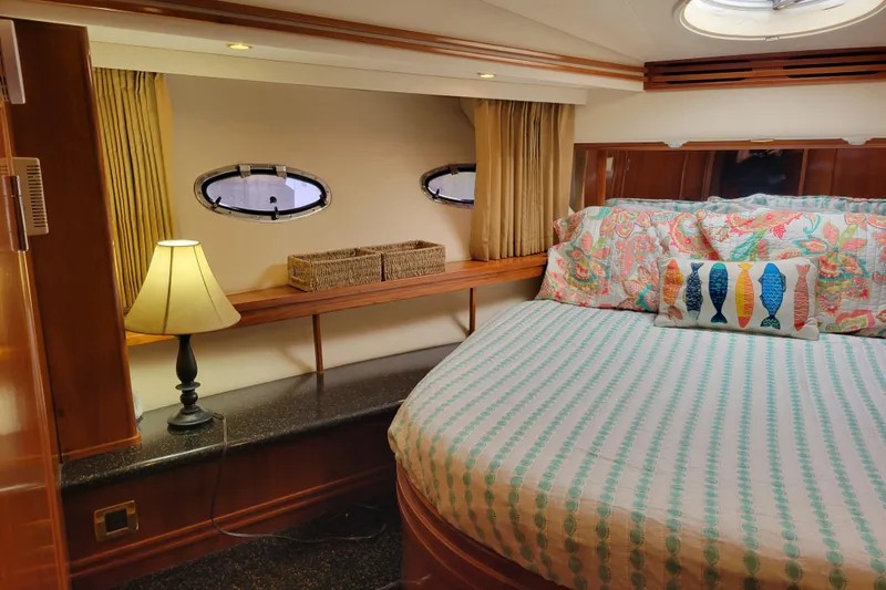  Yacht Photos Pics Cozy bedroom in 2001 Carver 570 Voyager Pilothouse with nautical decor and soft lighting.