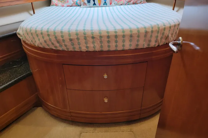  Yacht Photos Pics Interior of 2001 Carver 570 Voyager Pilothouse with wooden cabinetry and cushioned seating.