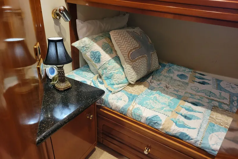  Yacht Photos Pics Cozy cabin bed with nautical-themed bedding in 2001 Carver 570 Voyager Pilothouse.