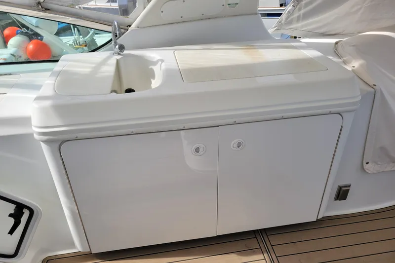  Yacht Photos Pics Outdoor sink and storage on 2001 Carver 570 Voyager Pilothouse yacht deck.