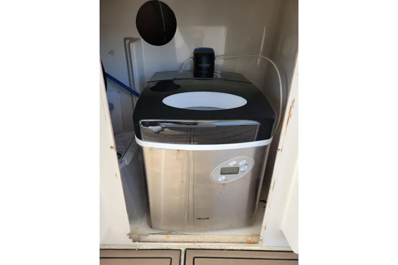  Yacht Photos Pics Portable ice maker inside 2001 Carver 570 Voyager Pilothouse yacht compartment.