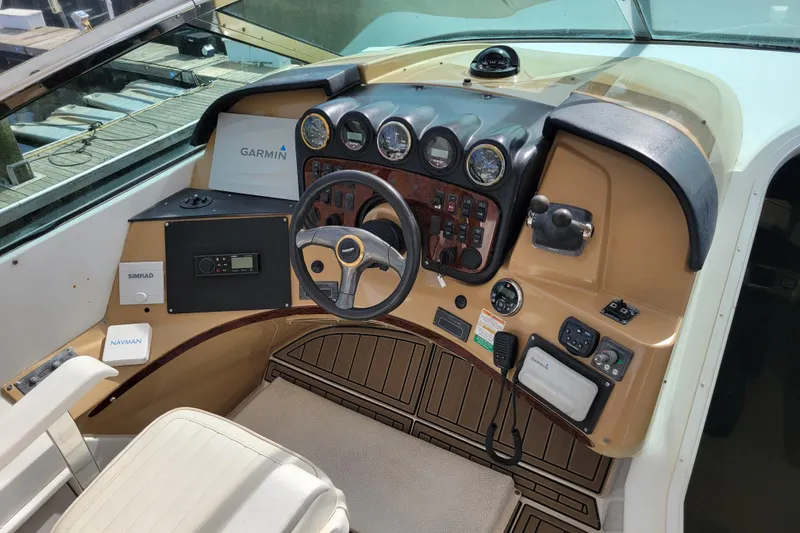  Yacht Photos Pics Pilothouse interior of 2001 Carver 570 Voyager with navigation equipment and steering controls.