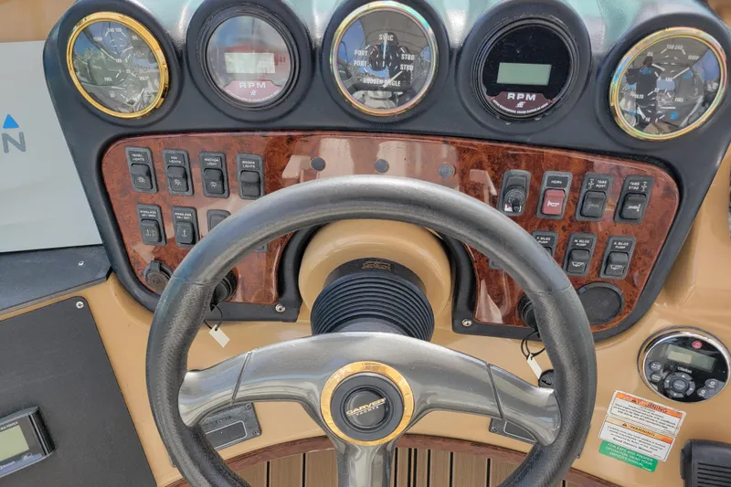  Yacht Photos Pics Control panel of a 2001 Carver 570 Voyager Pilothouse with steering wheel and gauges.