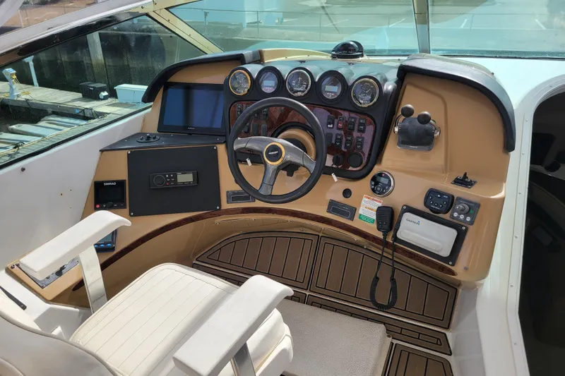  Yacht Photos Pics 2001 Carver 570 Voyager Pilothouse helm with steering wheel and navigation instruments.