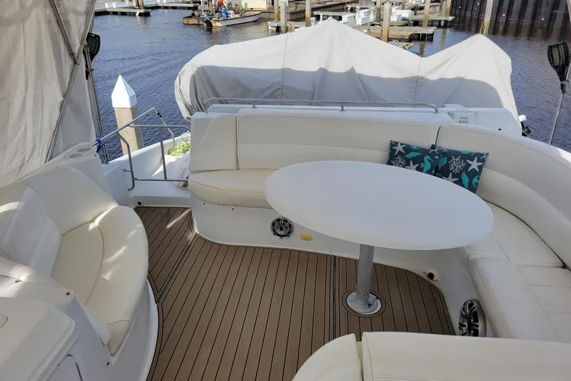  Yacht Photos Pics Luxurious 2001 Carver 570 Voyager Pilothouse yacht with elegant seating and table on deck.