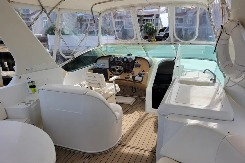  Yacht Photos Pics 2001 Carver 570 Voyager Pilothouse interior with helm, seating, and sink.