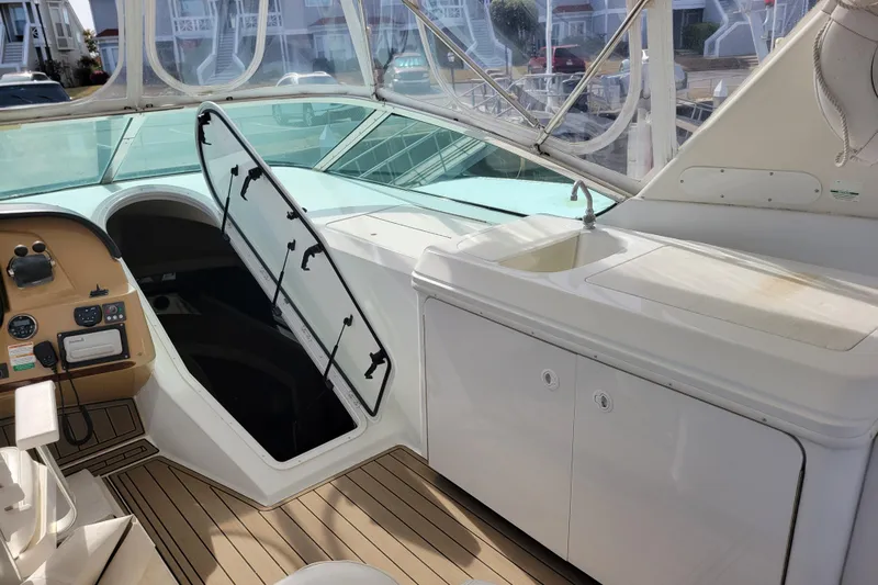  Yacht Photos Pics 2001 Carver 570 Voyager Pilothouse interior with helm, hatch, and sink area.