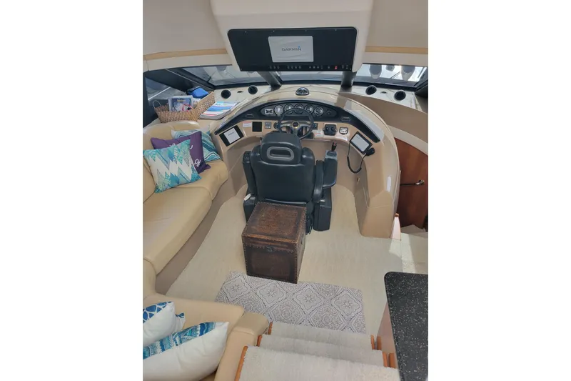  Yacht Photos Pics Pilothouse interior of 2001 Carver 570 Voyager with helm, seating, and nautical decor.