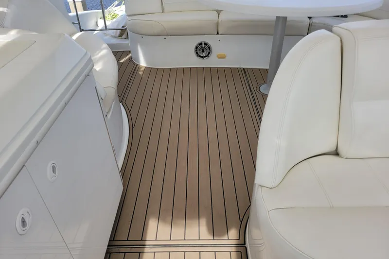  Yacht Photos Pics Luxurious interior of 2001 Carver 570 Voyager Pilothouse with white seating and wood flooring.