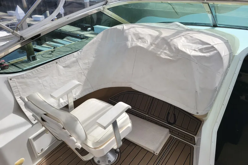  Yacht Photos Pics Captain's chair on 2001 Carver 570 Voyager Pilothouse, covered helm, dockside view.