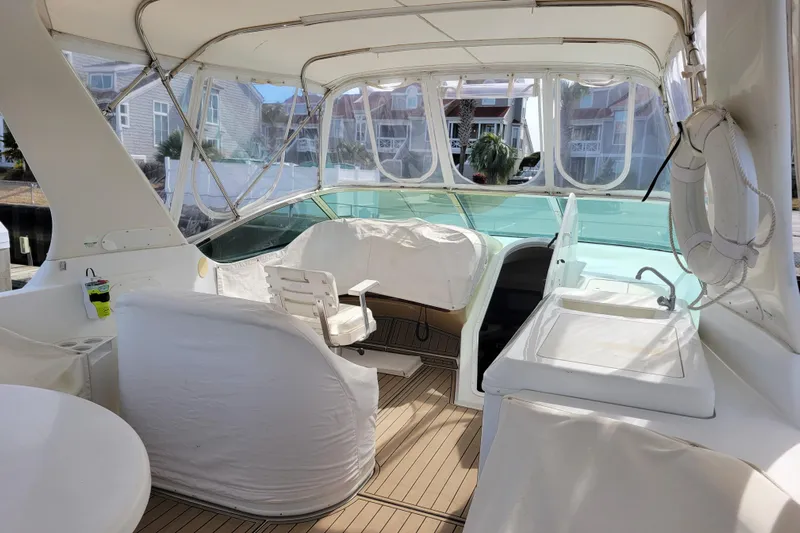  Yacht Photos Pics 2001 Carver 570 Voyager Pilothouse interior with covered seating and helm station.