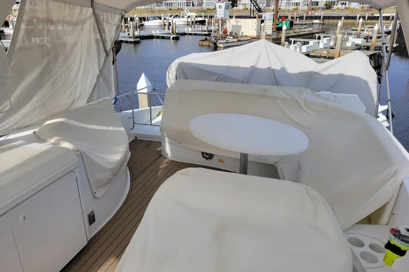  Yacht Photos Pics Covered seating area on a 2001 Carver 570 Voyager Pilothouse yacht at a marina.