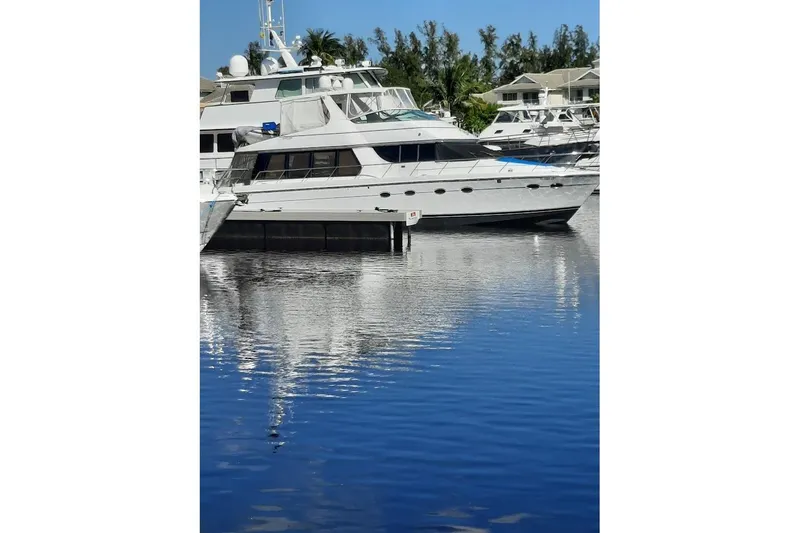  Yacht Photos Pics 2001 Carver 570 Voyager Pilothouse yacht docked in a serene marina setting.