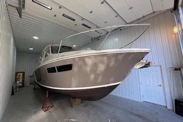  Yacht Photos Pics 2021 Pursuit OS 355 Offshore boat stored indoors, showcasing sleek design and modern features.