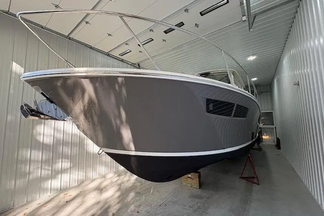  Yacht Photos Pics 2021 Pursuit OS 355 Offshore boat in storage, showcasing sleek design and modern features.