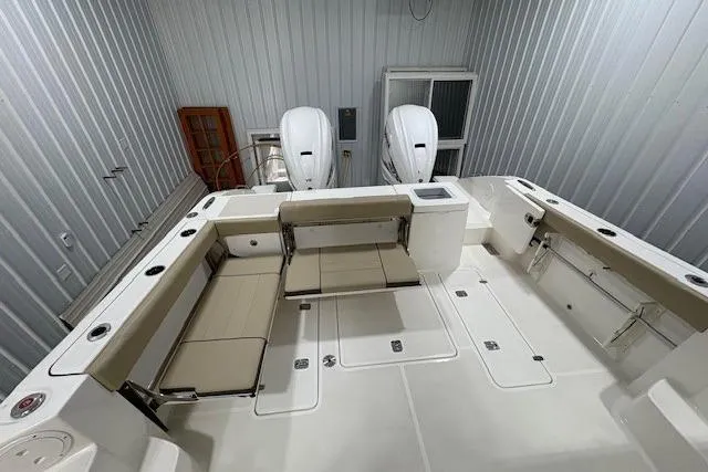  Yacht Photos Pics 2021 Pursuit OS 355 Offshore boat interior with seating and dual engines in storage.