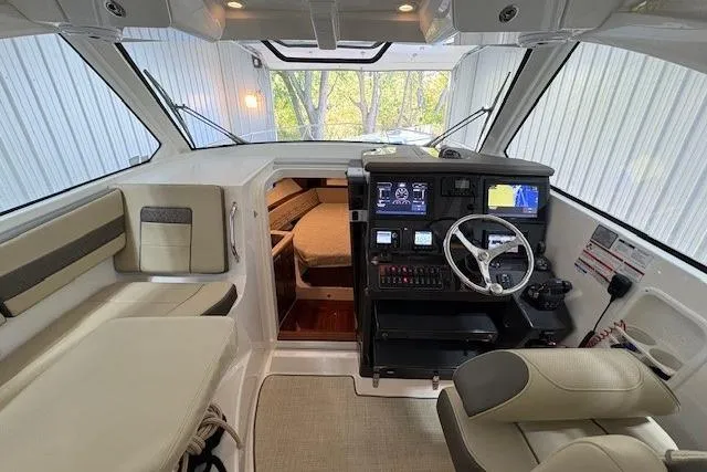  Yacht Photos Pics 2021 Pursuit OS 355 Offshore boat interior with helm, seating, and cabin view.