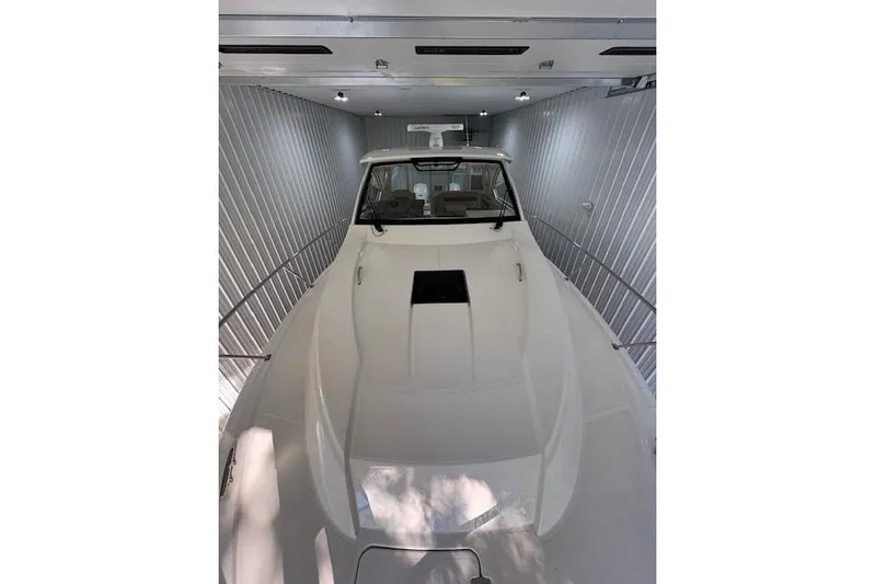  Yacht Photos Pics 2021 Pursuit OS 355 Offshore boat in storage, showcasing sleek design and modern features.