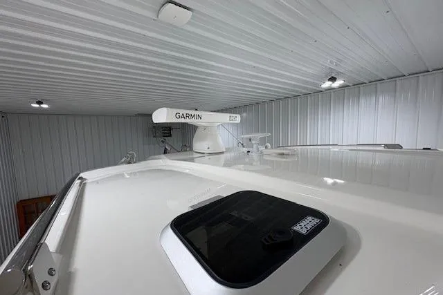  Yacht Photos Pics 2021 Pursuit OS 355 Offshore boat with Garmin radar in a metal storage facility.