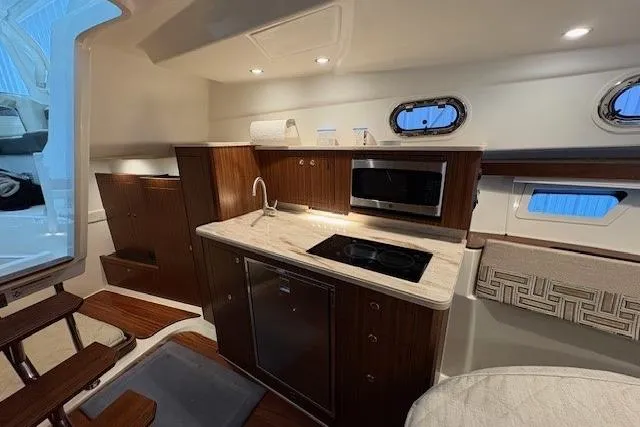  Yacht Photos Pics Interior of 2021 Pursuit OS 355 Offshore yacht with modern kitchen amenities.