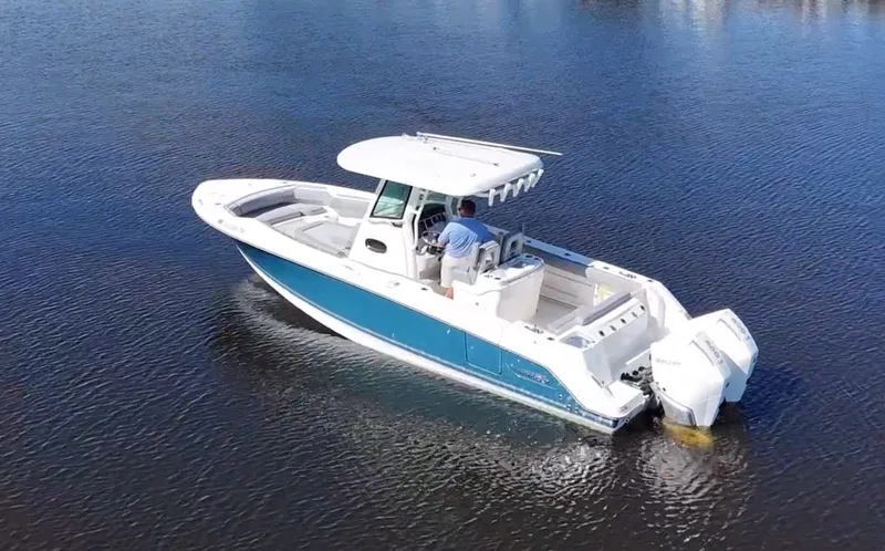  Yacht Photos Pics 2023 Boston Whaler 280 Outrage boat cruising on calm water.