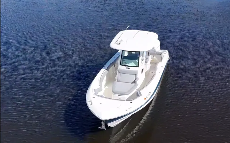  Yacht Photos Pics 2023 Boston Whaler 280 Outrage boat cruising on calm water.