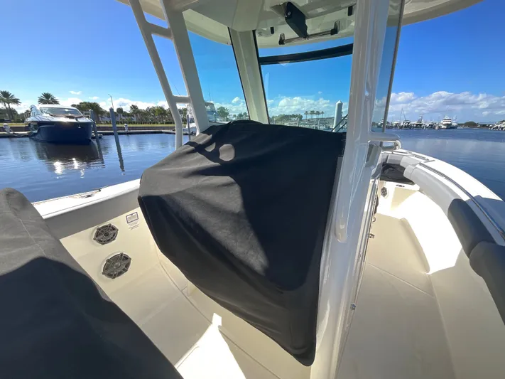  Yacht Photos Pics 2023 Boston Whaler 280 Outrage boat interior at marina, sunny day, covered console.