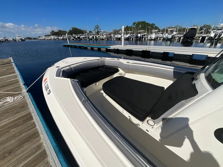  Yacht Photos Pics 2023 Boston Whaler 280 Outrage docked at marina, showcasing spacious seating and sleek design.