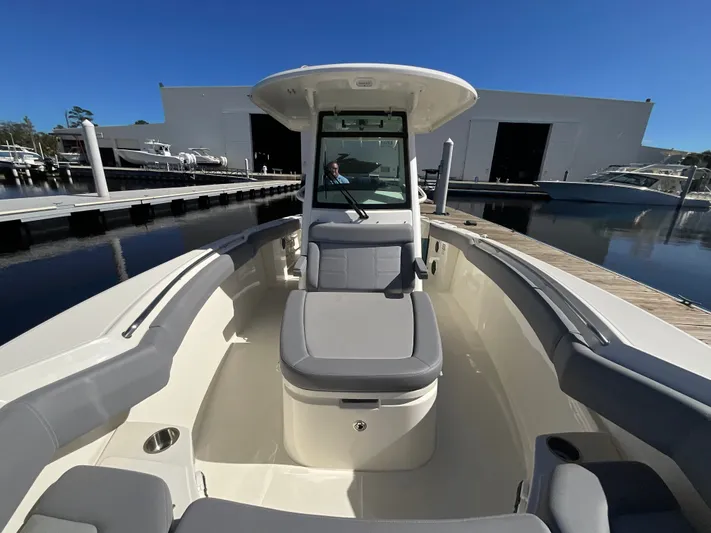  Yacht Photos Pics 2023 Boston Whaler 280 Outrage boat docked, showcasing spacious seating and sleek design.