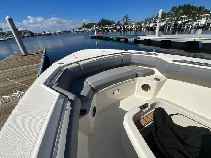  Yacht Photos Pics 2023 Boston Whaler 280 Outrage boat interior at marina dock, featuring spacious seating.