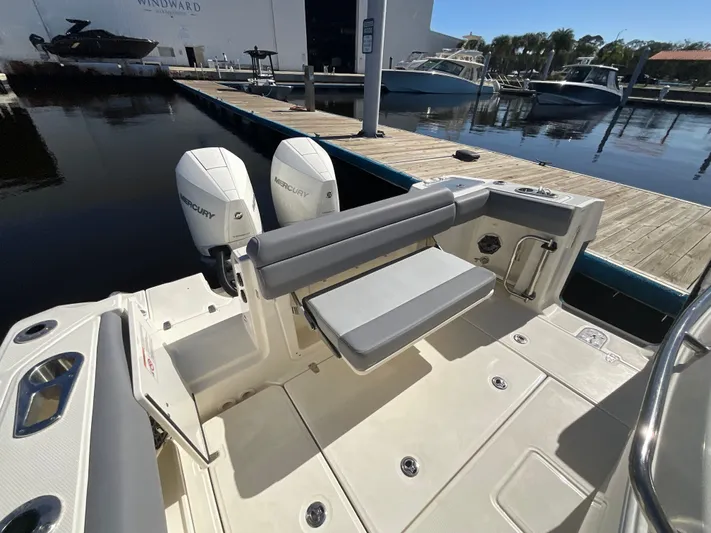  Yacht Photos Pics 2023 Boston Whaler 280 Outrage boat with dual Mercury engines at a marina dock.