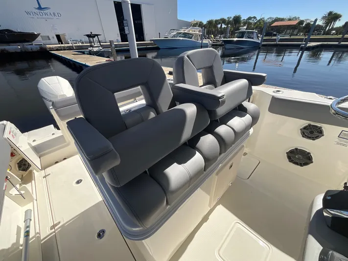  Yacht Photos Pics 2023 Boston Whaler 280 Outrage boat interior with gray seating at marina.