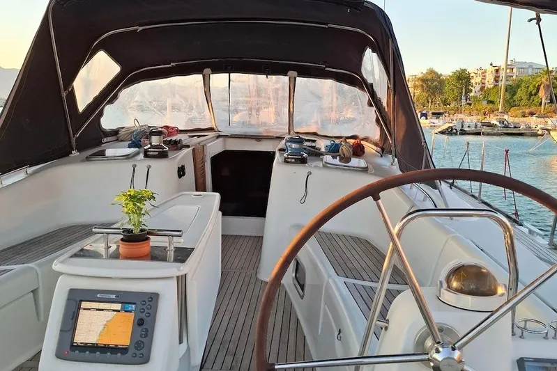  Yacht Photos Pics Cockpit of 2009 Beneteau Oceanis 54 yacht with steering wheel and navigation equipment.