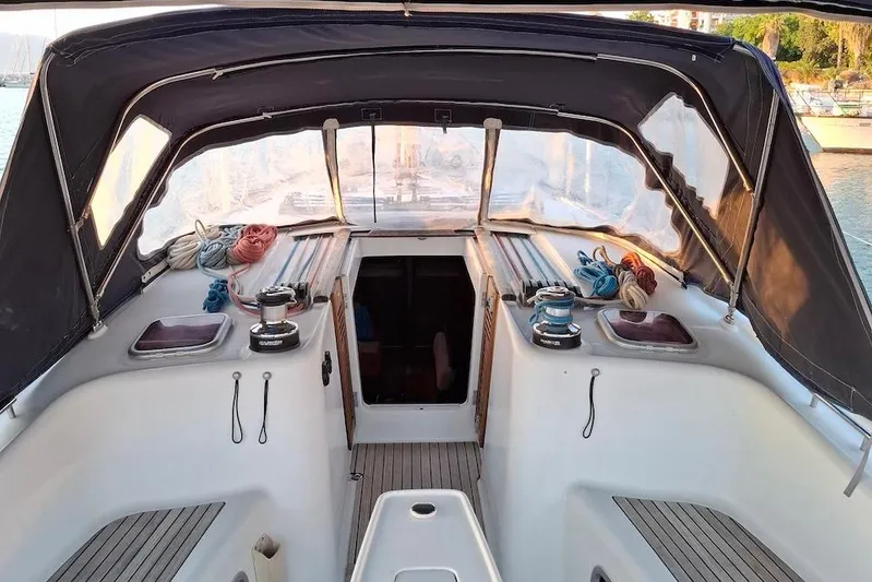  Yacht Photos Pics 2009 Beneteau Oceanis 54 cockpit with ropes and winches, sheltered by a canopy.