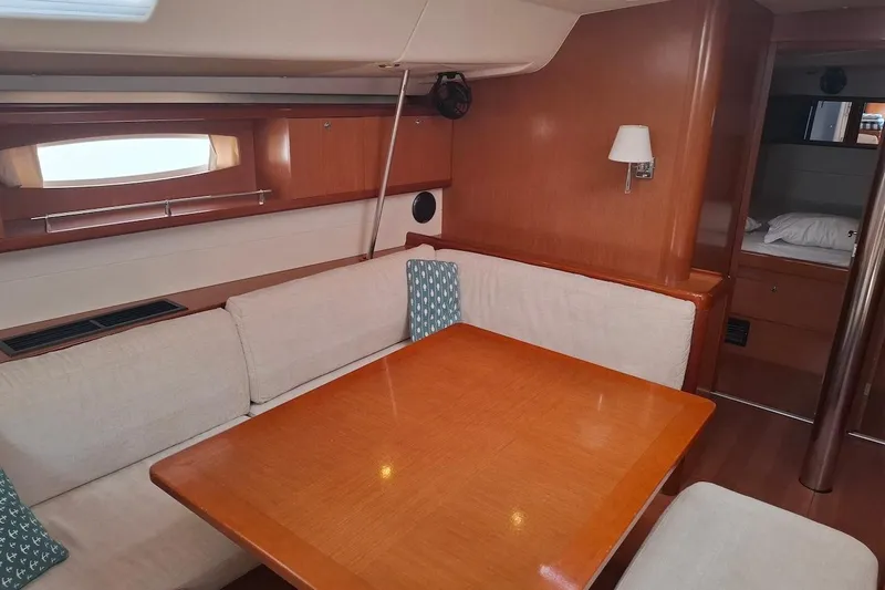  Yacht Photos Pics Interior of 2009 Beneteau Oceanis 54 yacht with wooden dining area and seating.