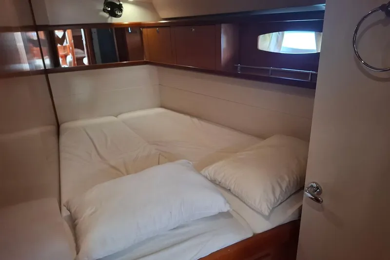  Yacht Photos Pics Cozy cabin interior of 2009 Beneteau Oceanis 54 yacht with comfortable bedding.
