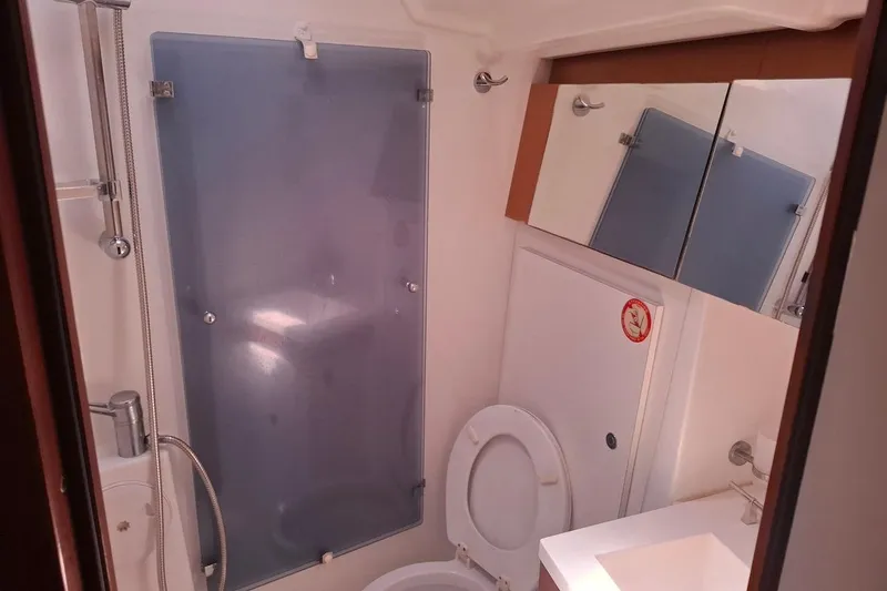  Yacht Photos Pics Bathroom interior of 2009 Beneteau Oceanis 54 yacht, featuring shower and toilet.