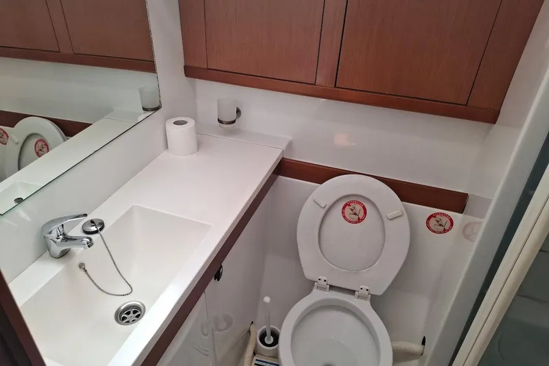  Yacht Photos Pics Bathroom interior of 2009 Beneteau Oceanis 54 yacht with sink and toilet.