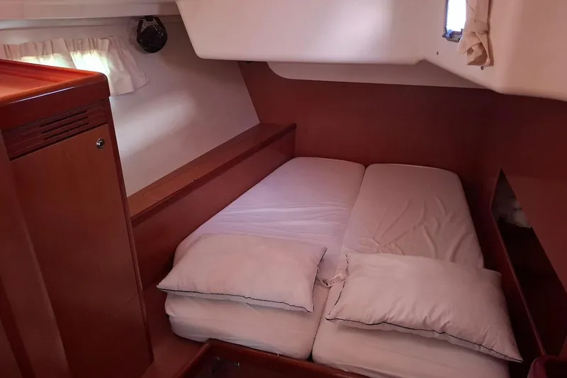  Yacht Photos Pics Cozy cabin interior of 2009 Beneteau Oceanis 54 yacht with double bed and pillows.