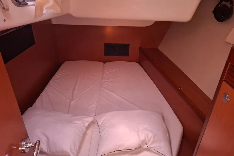  Yacht Photos Pics Cozy cabin interior of 2009 Beneteau Oceanis 54 sailboat with double bed.