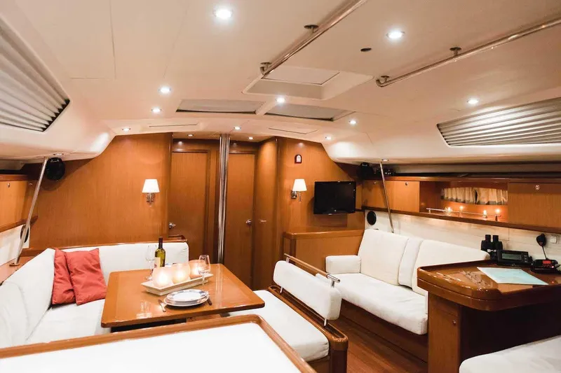  Yacht Photos Pics Luxurious interior of 2009 Beneteau Oceanis 54 yacht with elegant seating and dining area.