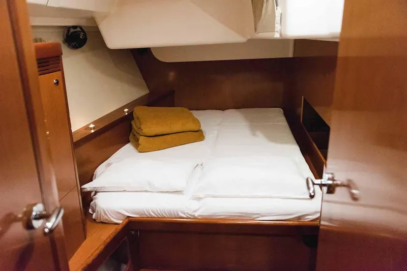  Yacht Photos Pics Cozy cabin interior of 2009 Beneteau Oceanis 54 yacht with neatly arranged bedding.