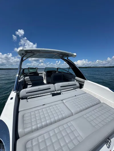  Yacht Photos Pics 2022 Cobalt R30 boat with spacious seating on a sunny day at sea.