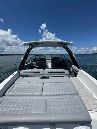  Yacht Photos Pics 2022 Cobalt R30 boat with spacious seating on a sunny day at sea.