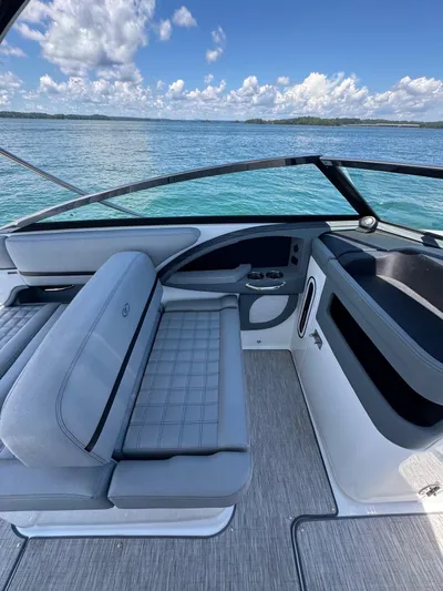  Yacht Photos Pics 2022 Cobalt R30 boat interior with gray seating, overlooking serene blue waters.