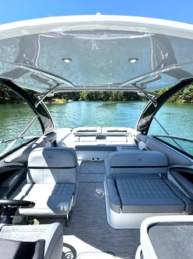  Yacht Photos Pics 2022 Cobalt R30 boat interior with luxurious seating on a serene lake.