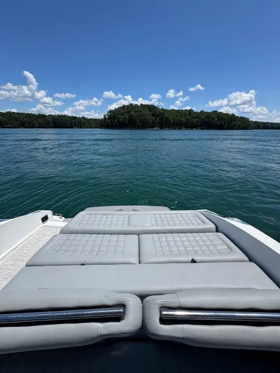  Yacht Photos Pics 2022 Cobalt R30 boat with sunpad, overlooking serene lake and lush island.